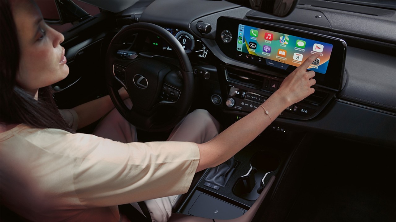 A person interacting with a Lexus touchscreen display