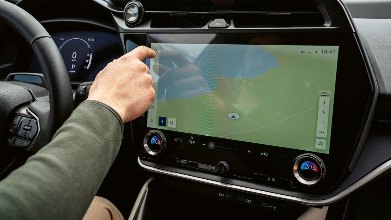 A person interacting the Lexus RZ 450e's touch screen